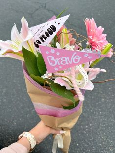 a person holding a bouquet of flowers with a sign that says bake on it