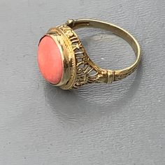 We take pride in finding unique , quality ~ Antique /Vintage jewelry pieces which are carefully hand picked by us so that you can add them to your treasure/ collection or gift to someone you love ~ We try to add plenty of items every week and have been selling online for more then 10 years . Vintage Art Deco ~ 14kt solid gold ~ filigree ring with ta large geuine coral can which is set on an open-back frame . Marked 14kt (also acid tested ) Dates 1920's -1930's Measurements : Ring can fit 6 1/2 - Yellow Gold Filigree Jewelry Ring, Classic Intricate 14k Gold Jewelry, Yellow Gold Engraved Filigree Ring, Yellow Gold Engraved Ring With Filigree, Heirloom 14k Gold Ring With Intricate Design, 14k Yellow Gold Filigree Ring, Heirloom 14k Gold Rings With Intricate Design, Carved Ring Fine Jewelry, Antique Carved Rings For Anniversary