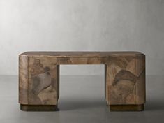 a wooden table sitting on top of a cement floor next to a white wall and grey walls