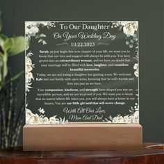 a glass plaque with the words to our daughter on it sitting on a table next to a potted plant