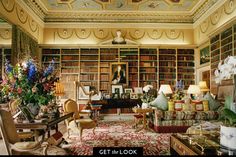 a living room filled with lots of furniture and bookshelves