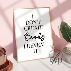 a sign that says i don't create beauty reveal it next to a potted plant