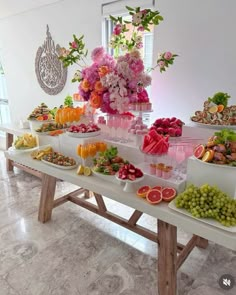 a table filled with lots of different types of fruits and veggies on it