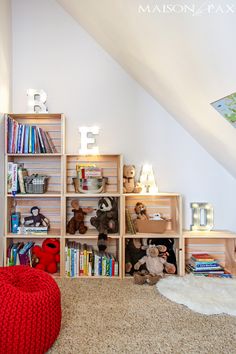 a room with bookshelves and stuffed animals on the floor