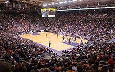 an indoor basketball court filled with people