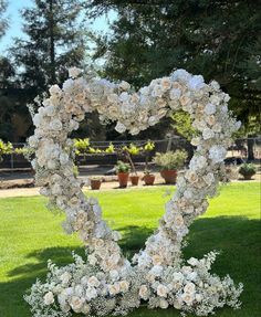 a heart shaped flower arrangement in the grass