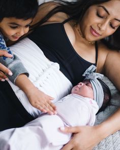 a woman holding a baby in her arms