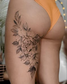 a woman's thigh with flowers on it