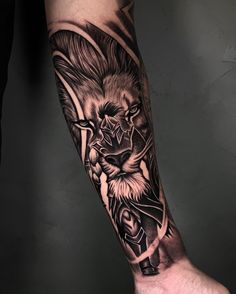 a man's arm with a lion tattoo on it