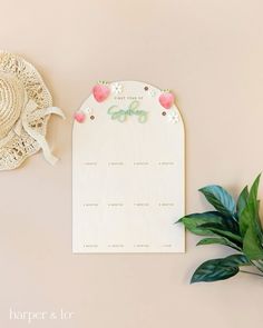 a table with a hat and flowers on it next to a paper sign that says happy