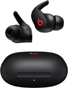 the beats by dr dre earbuds are black and have red logo on them