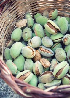 a basket filled with nuts sitting on top of a cement floor