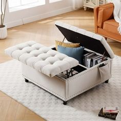 a white ottoman sitting on top of a rug in a living room