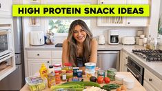 a woman standing in front of a kitchen counter with food on it and the words high protein snack ideas