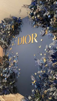 the entrance to dior is decorated with blue flowers and gold foil lettering that says dior