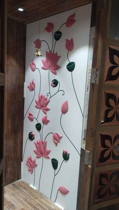 the wall is decorated with pink flowers and green leaves