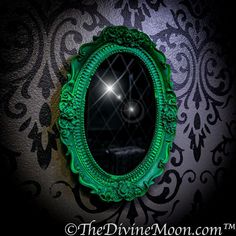 a green mirror on the wall with a light shining through it's reflection in the mirror