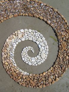 there is a spiral design made out of rocks