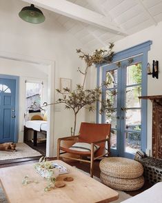 a living room filled with furniture and a tree in the middle of it's center