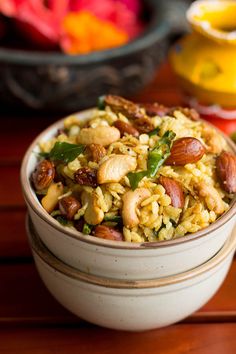 a bowl filled with rice and nuts on top of a table