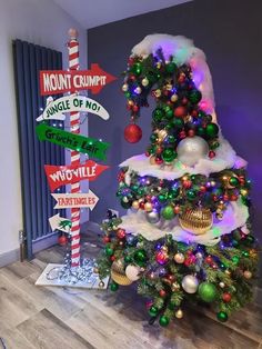 a christmas tree decorated with street signs and ornaments