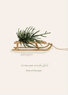 a christmas card with a sled filled with pine needles