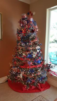 a decorated christmas tree with red, white and blue decorations