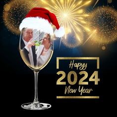 a happy new year card with fireworks and a photo in a wine goblet