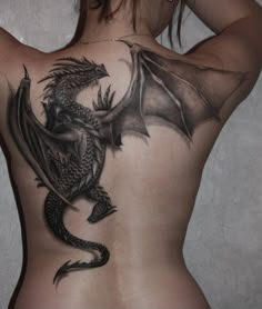 a woman with a dragon tattoo on her back