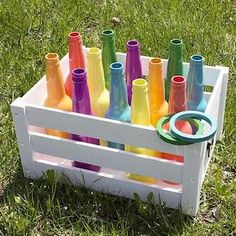 a box filled with lots of different colored bottles next to the words, bottle ring toss game take the fun and games outside this summer