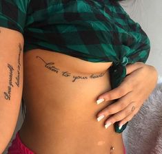 a woman's stomach with tattoos on it and the words, love is your heart