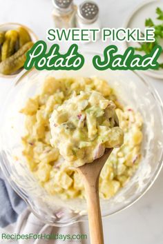 a spoon full of potato salad on top of a glass plate