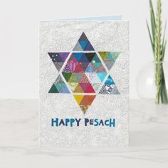 a card with the words happy pesah written on it and an image of a star of david in colorful mosaics