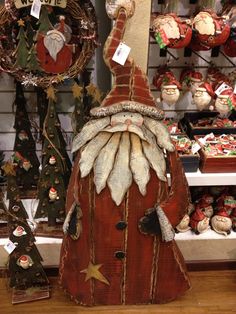 a wooden santa clause is on display in a store