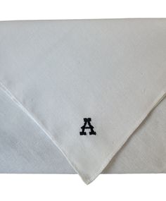 a white shirt with the letter a embroidered on it