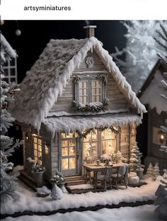 a small house with snow on the roof and windows is lit up at christmas time