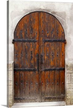 an old wooden door with iron bars on it