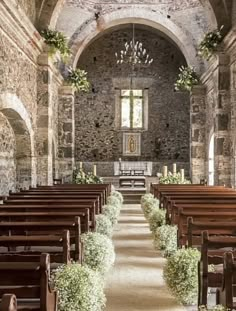 an image of the inside of a church with pews and flowers on it's side