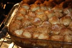 a baking dish filled with cinnamon rolls in the oven