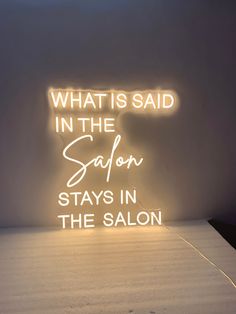 a neon sign that says what is said in the safn stays in the salon