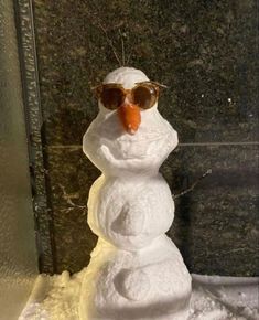 a snowman with sunglasses on top of it