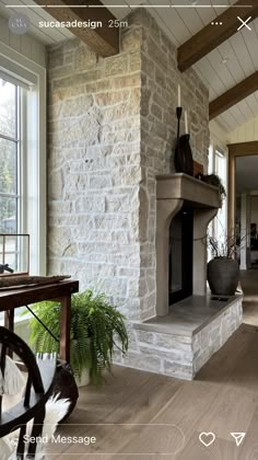 a living room filled with furniture and a fire place in the middle of a room