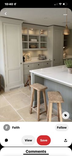 a kitchen with two stools in it next to a counter top and an island