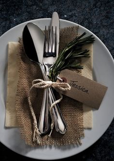 a white plate topped with silverware on top of a table