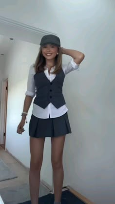 a woman in a skirt and hat posing for the camera