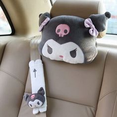 a car seat with a stuffed animal head on it's back end, and an arm rest in the front