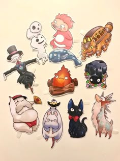 various cartoon stickers sitting on top of a white surface