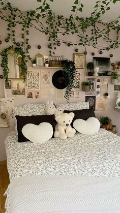 a white teddy bear sitting on top of a bed in a room filled with plants