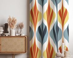 an orange, blue and yellow curtain in a living room