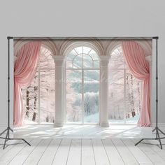 an open window with pink curtains in front of it and snow covered trees outside the window